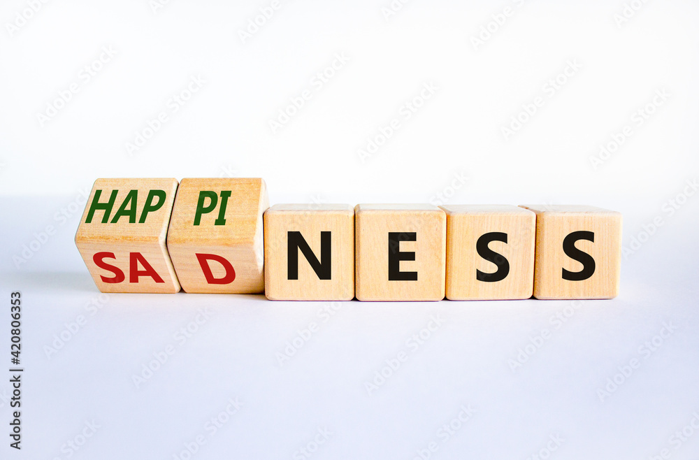 Happiness or sadness symbol. Turned cubes and changed the word 'sadness' to 'happiness'. Beautiful white background. Business, psychological and happines or sadness concept. Copy space. Happiness or sadness symbol. Turned cubes and changed the word 'sadness' to 'happiness'. Beautiful white background. Business, psychological and happines or sadness concept. Copy space.