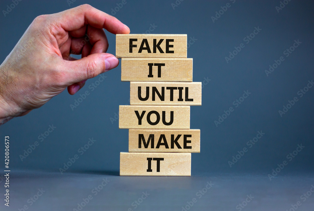 Fake it until you make it symbol. Wooden blocks with words 'Fake it