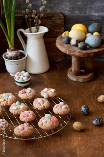 Cinnamon cookies, Easter eggs, colorful chocolate eggs. Side view.