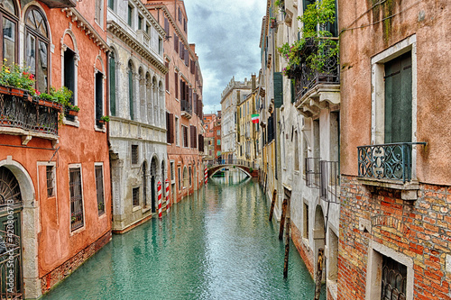 Canal with boats in Venice (Italy) on a cloudy day in late autumn
