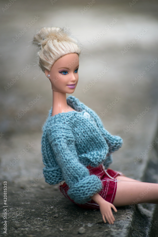 Mulhouse - France - 16 March 2021 - Portrait of Barbie doll with woolen  pullover and sexy red short sitting in the street foto de Stock | Adobe  Stock