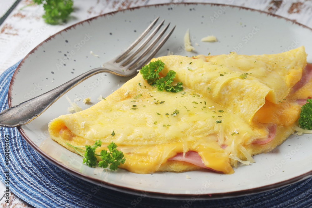 Omelette with ham and cheese on the plate Omelette with ham and cheese on the plate