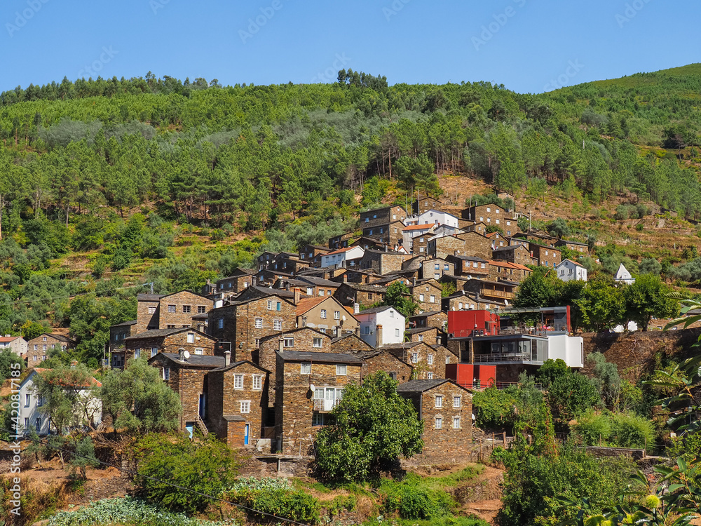 Small medieval Portuguese town. Famous village Piódão, built of dark stones, is located on a hillside in the mountains Serra do Açor, Portugal. Old city is popular tourist destination.