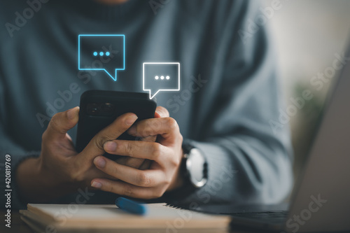 Photography Women hand using smartphone typing Live chat chatting and social network concepts, chatting conversation working at home in chat box icons pop up