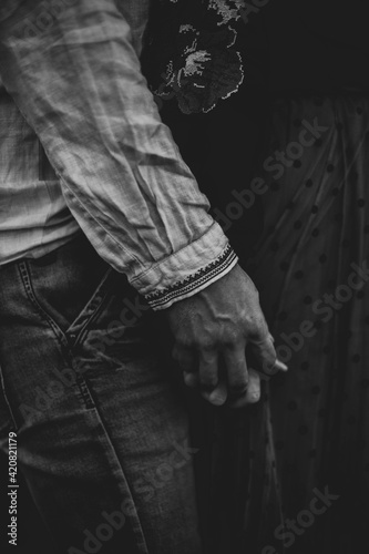 Young couple in love holding hands. Black and white photo
