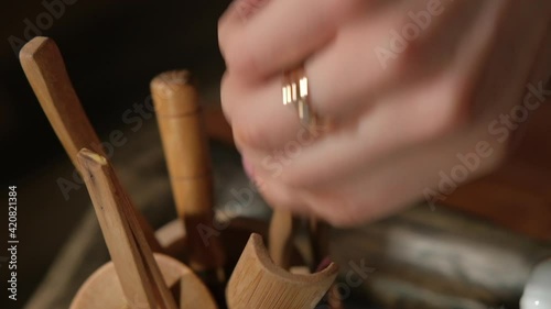 Teamaster begins the classical Chinese tea ceremony. Warms up the kettle for the ceremony. Pours water into a kettle and brews Chinese tea. Pours tea through a strainer. Authentic tea paraphernalia. photo