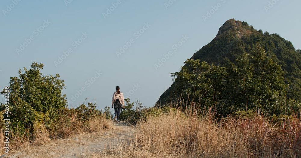 Woman go hiking to the top of the mountain