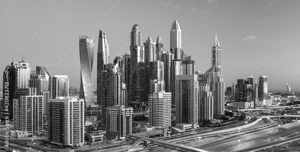 DUBAI, UNITED ARAB EMIRATES - MARCH 10, 2016: People relaxing on Jumeirah beach in Dubai Marina luxury hotels,United Arab Emirates