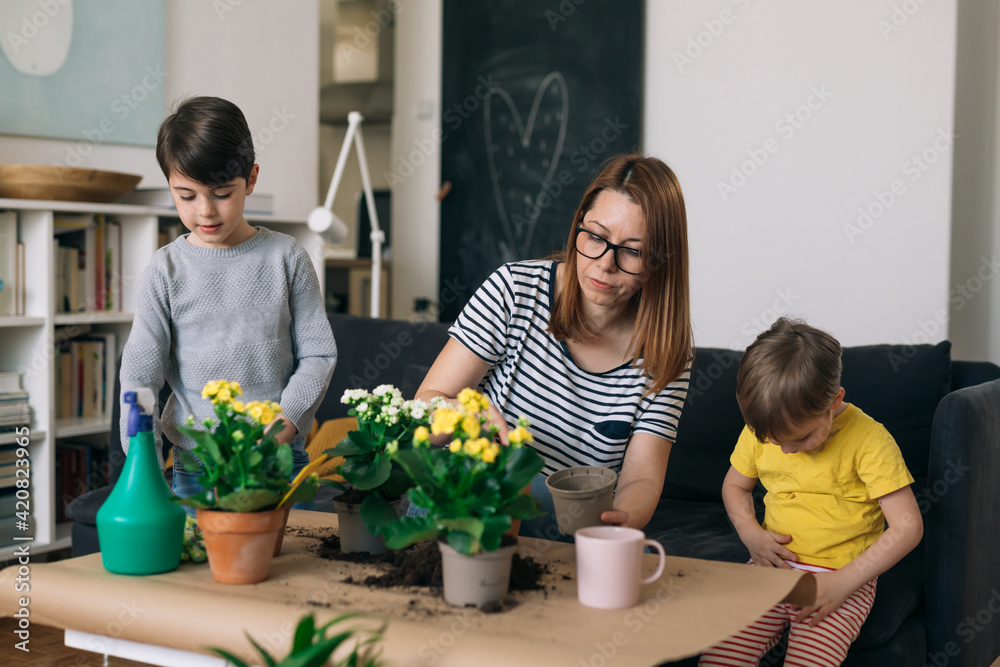 mother and her children gardening at home mother and her children gardening at home