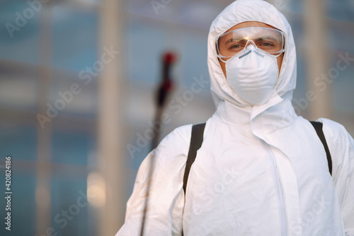Portrait of Man in protective hazmat suit and mask. Covid-2019. Prevention of spreading global pandemic pneumonia virus.