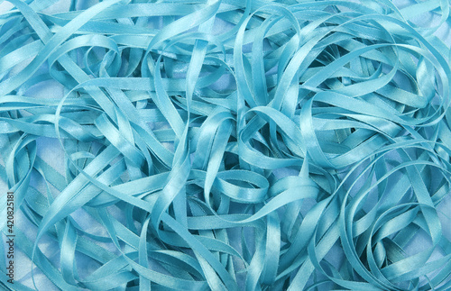Blue satin shiny fabric background. wavy satin blue ribbon.Backgrounds; Textured; Textile; Silk