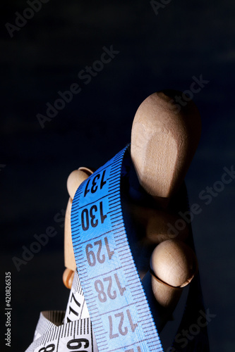 wooden mannequin  with measuring tape