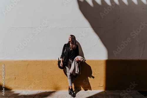 young woman waiting for her friends in the sun