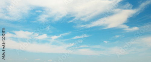 Fluffy clouds on bright blue sky