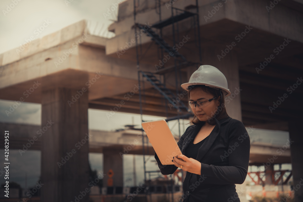 Engineer woman working at site of bridge under construction Engineer woman working at site of bridge under construction