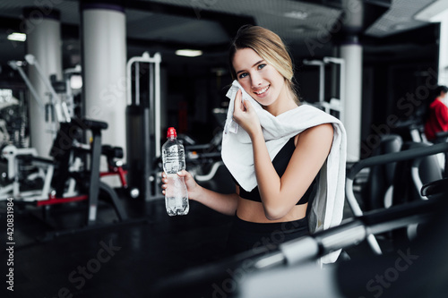 Smiling blonde girl after training in the gym smiling looking at the camera, healthy lifestyle, healthy body