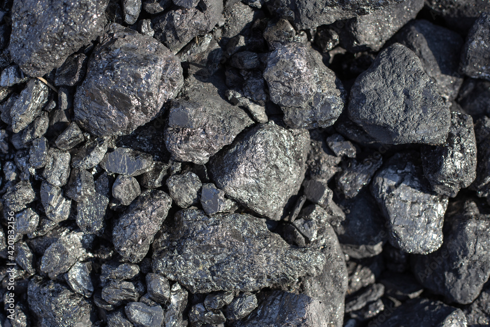 Large shiny lumps of coal. Mineral, mineral fuel for home stoves and boilers in a country house. Large shiny lumps of coal. Mineral, mineral fuel for home stoves and boilers in a country house.