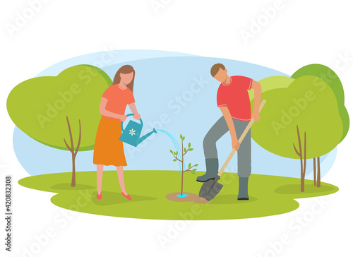 Woman and man planted a tree in the park.