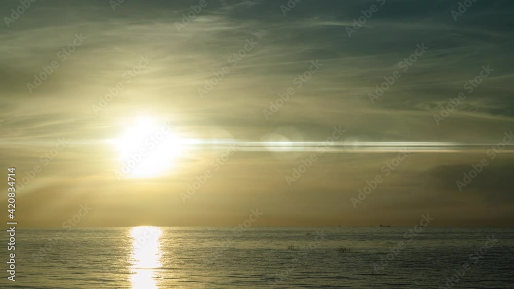 Time lapse sunrise beach Australia. Clouds fast in the sky. Time-lapse of fast flying clouds in the sky. The big sun rises from behind the clouds. Time lapse sunrise beach Australia. Clouds fast in the sky. Time-lapse of fast flying clouds in the sky. The big sun rises from behind the clouds.
