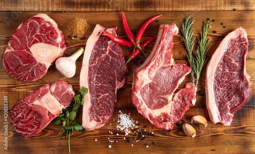 Pieces of meat of different types on the board. Beef. Pepper, garlic, rosemary. Top