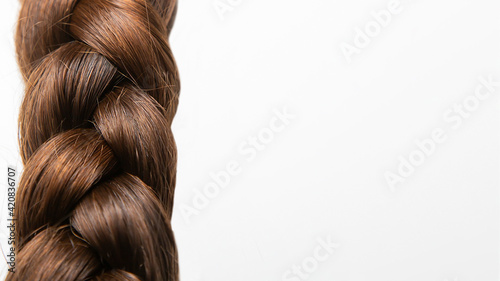 A braid of hair on a white background. Top view. Close-up. Hair style. Hair. Hair care.