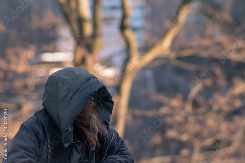 Homeless man with long beard on Central Park. 