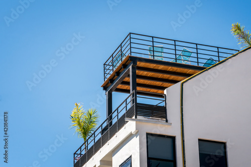 Modern house design with wooden rooftop balcony, exterior.