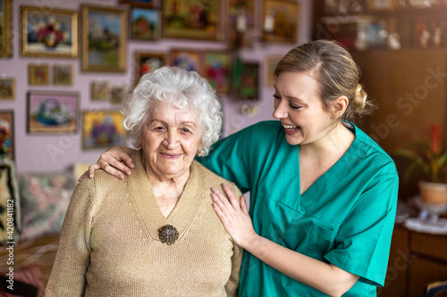 Konstfotografi Friendly nurse supporting an elderly lady