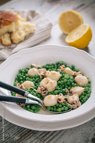 Cuttlefish with peas on a plate. High quality photo.