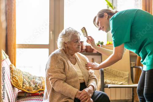 Female nurse taking care of a senior woman at home
 photo