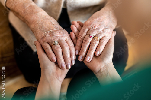 Cropped shot of a senior woman holding hands with a nurse

