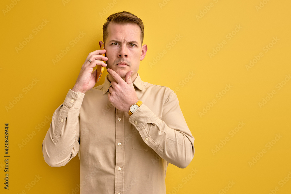 guy sharing ideas with business partner while talking on phone