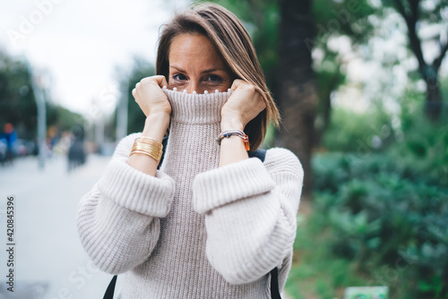 Stylish woman in warm sweater on street