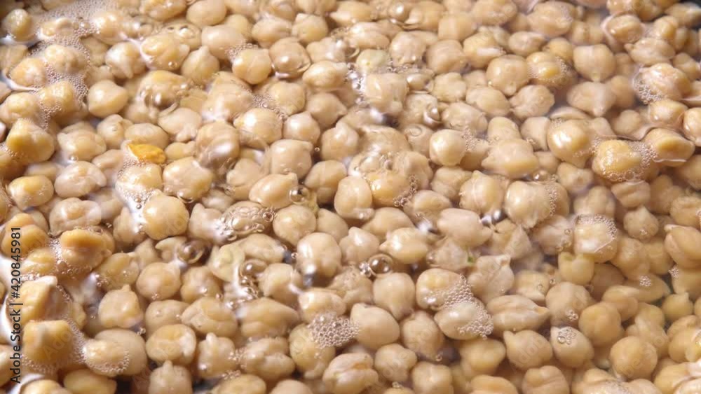 Raw chickpeas, bean with bubbles. Close-up top view, the preparation of hummus Raw chickpeas, bean with bubbles. Close-up top view, the preparation of hummus