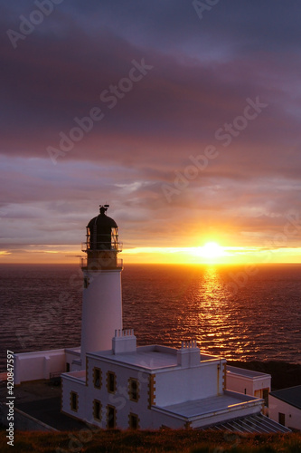 A lighthouse in Scotland near Melvaig during sunset 