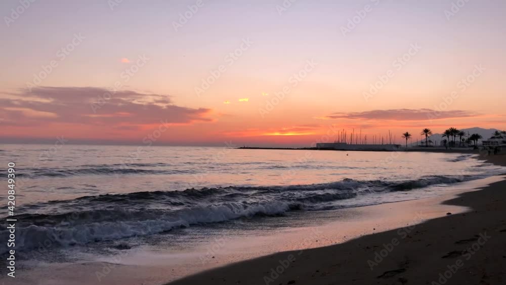 Sunset on the sea coast, nature is painted in orange shades of the sun. The waves of the sea are splashing. Video in 4K. Sunset on the sea coast, nature is painted in orange shades of the sun. The waves of the sea are splashing. Video in 4K.