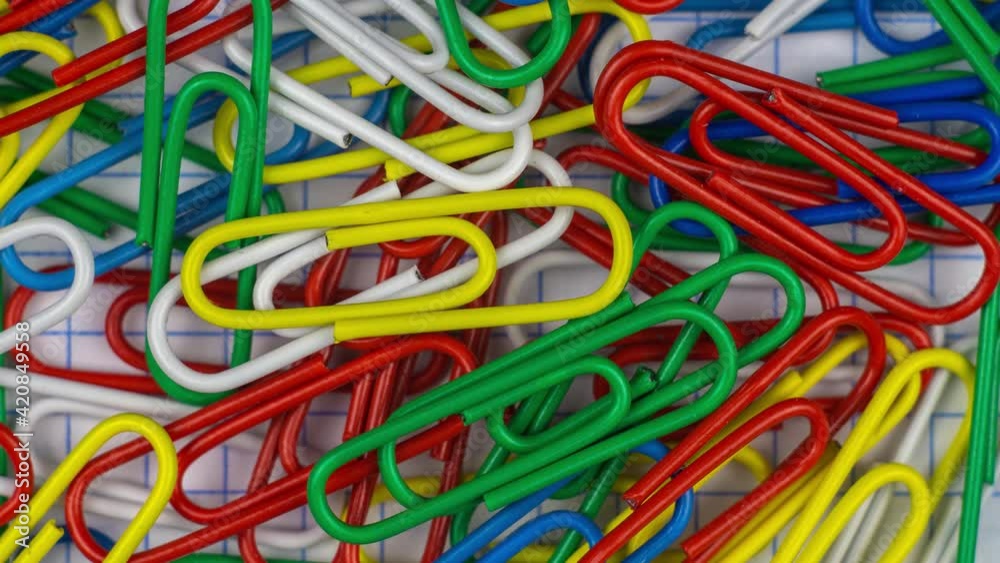 Stop motion animation. Multicolor paper clips animated background. Office concept Stop motion animation. Multicolor paper clips animated background. Office concept