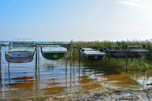 Boats suspended above the water at the lake shore