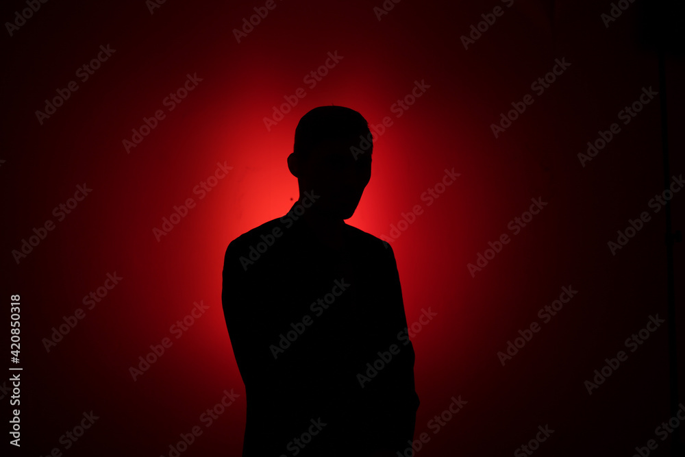 Silhouette of a man on a red background. Silhouette of a man on a red background.