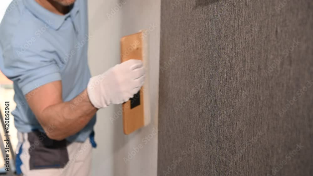 Vinyl Wallpaper Installation with Squeegee Tool. Caucasian Men Applying