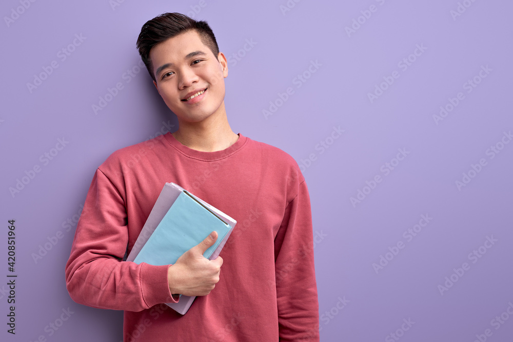 Chinese guy with book in hands enjoy education and university, posing Chinese guy with book in hands enjoy education and university, posing