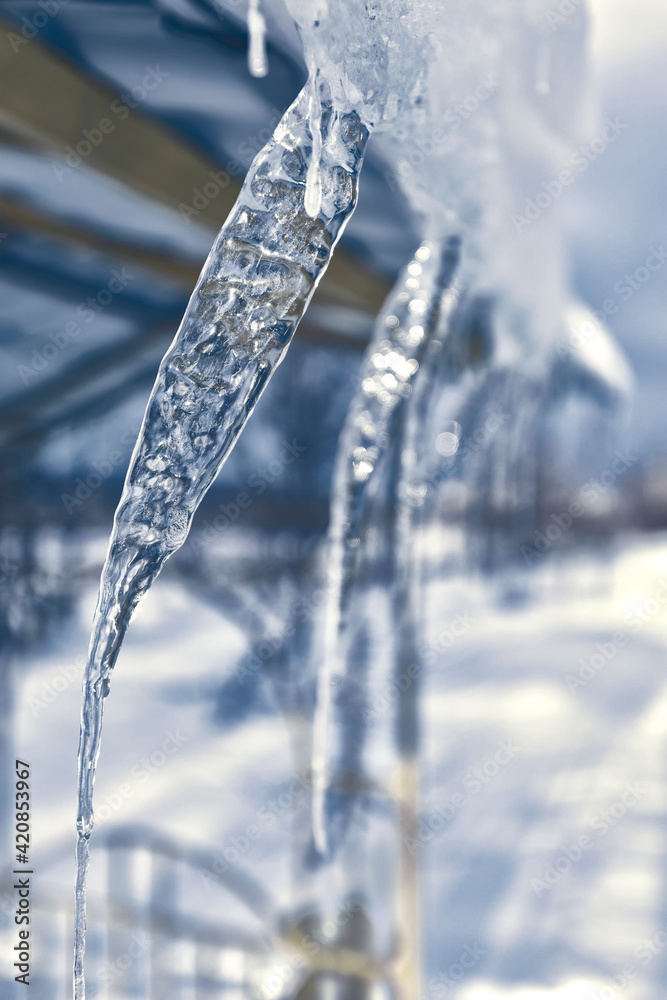 Warming in winter, icicles hanging from the roof. Warming in winter, icicles hanging from the roof.