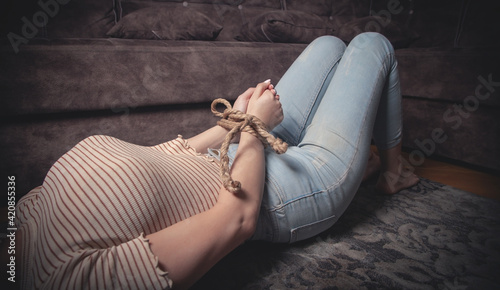 Photography Hands of a victim woman tied with rope.