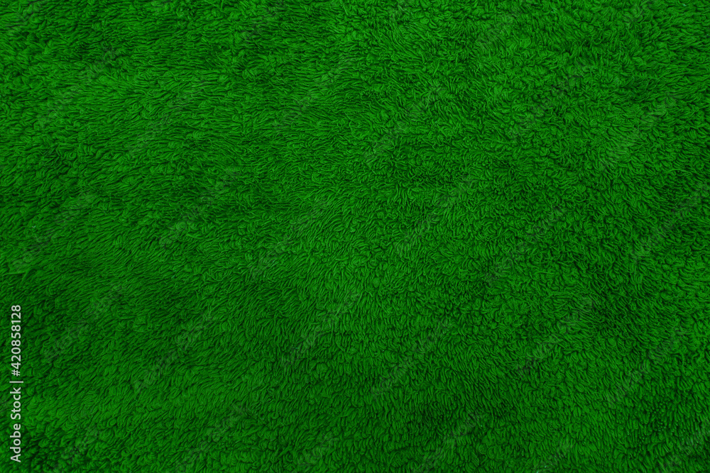Terry towel texture. Soft fabric background. Green towel.
