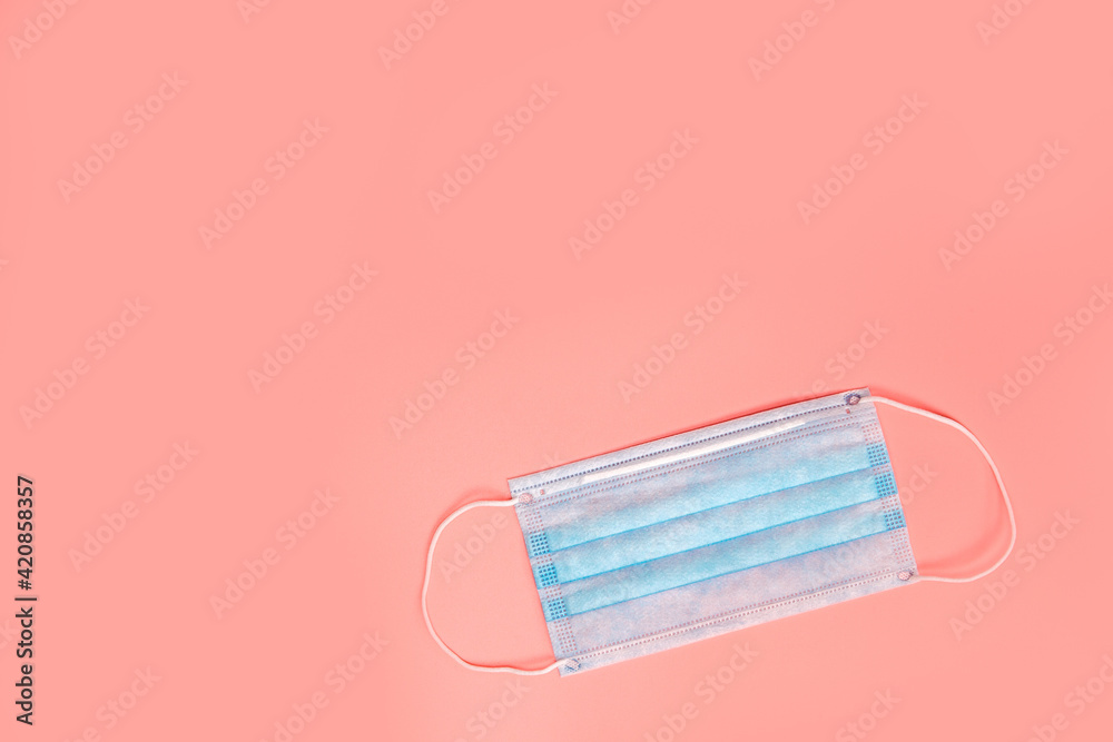 Medical disposable protective face masks on a pink background. The concept of protecting health from the virus. Copy space, top view. flat lay Coronavirus, covid-19,business, health concept Medical disposable protective face masks on a pink background. The concept of protecting health from the virus. Copy space, top view. flat lay Coronavirus, covid-19,business, health concept