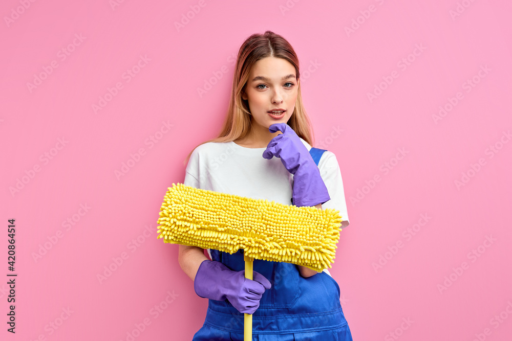 pleasant lady confident house wife in good mood hold cleaning equipment isolated on pink pleasant lady confident house wife in good mood hold cleaning equipment isolated on pink