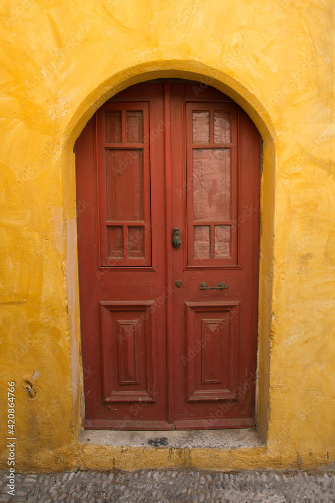 Colorful walls and wooden door in Rhodes old town, Dodecanese, Greece