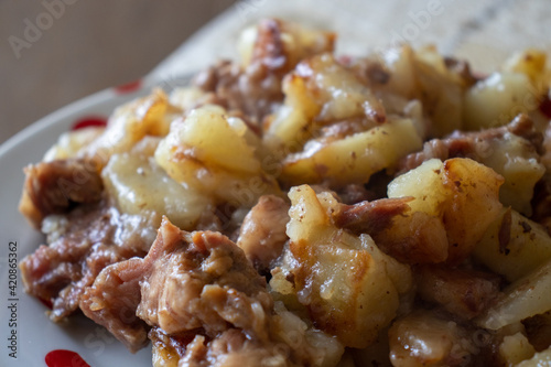 Grilled meat and vegetables. Potatoes with meat on a plate