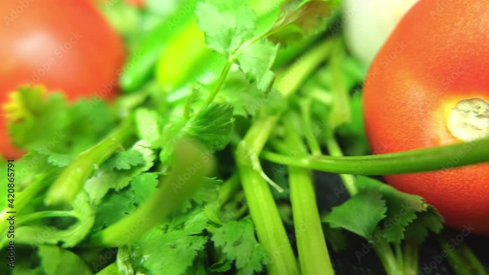 Chili peppers, onion, and a tomatoes above coriander Chili peppers, onion, and a tomatoes above coriander