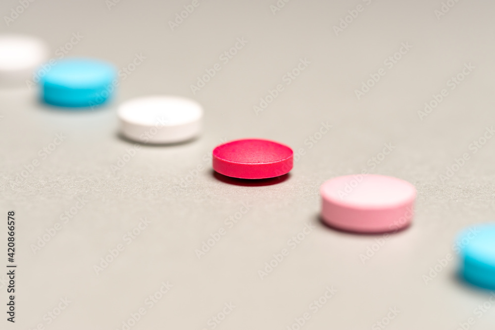 Diagonal row of tablets of different colors on grey background Diagonal row of tablets of different colors on grey background